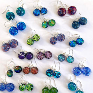 Drop Earrings in Dichroic glass, displayed on wildflower seeded card.